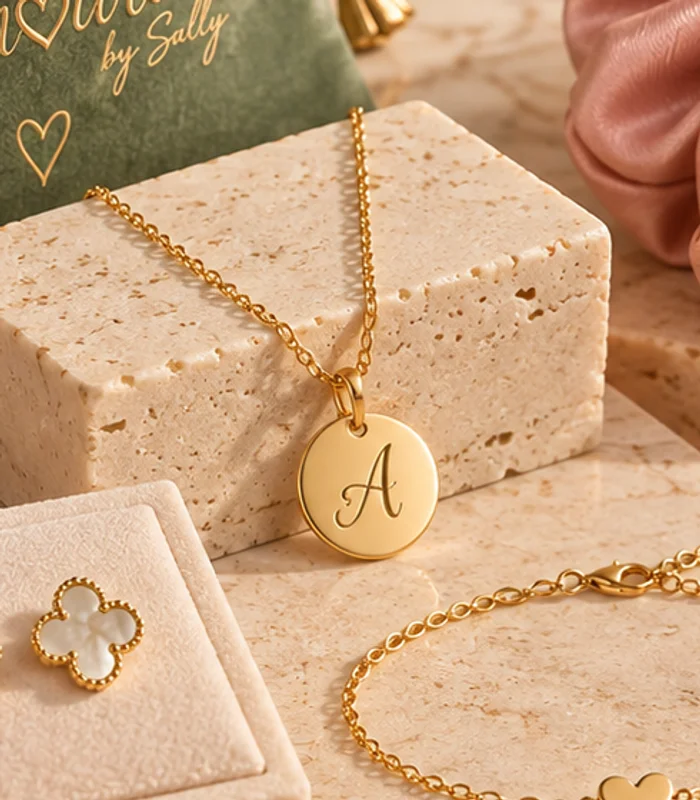 An initial pendant, styled on warm stone